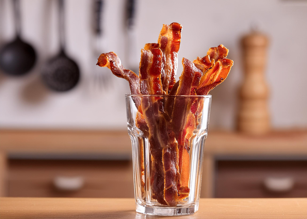 Hot Honey Dust Candied Bacon in a glass to be served