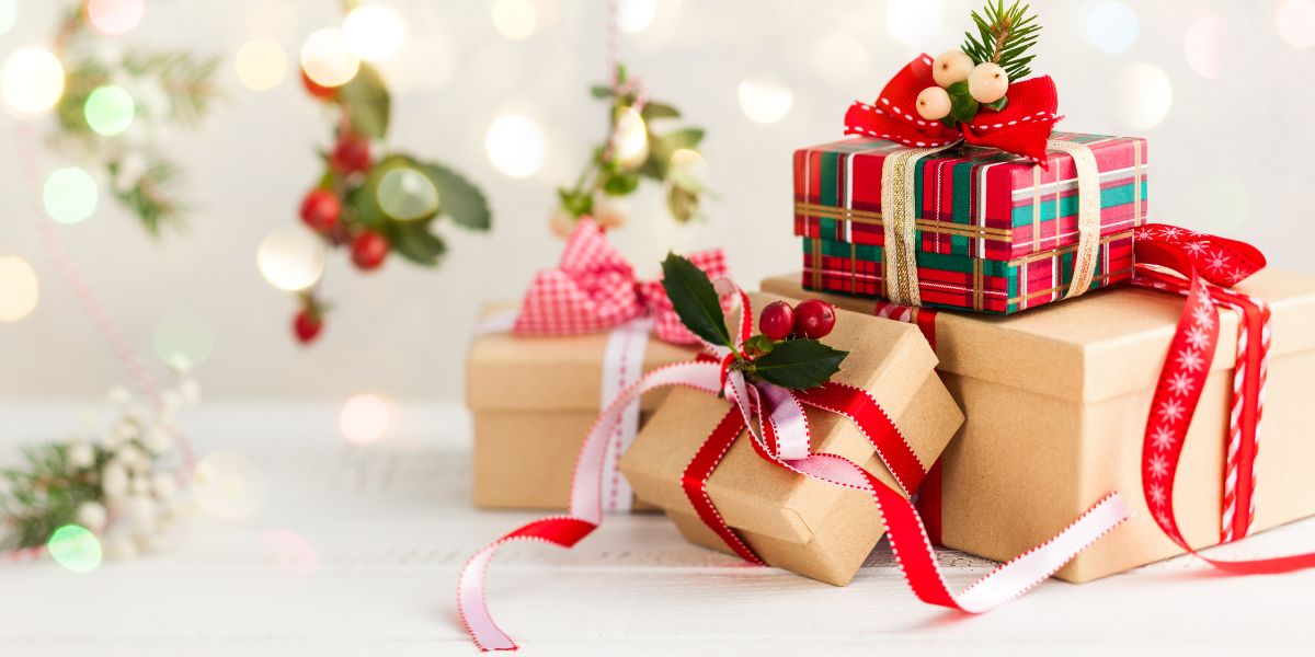 A stack of red and brown gift-wrapped holiday gifts